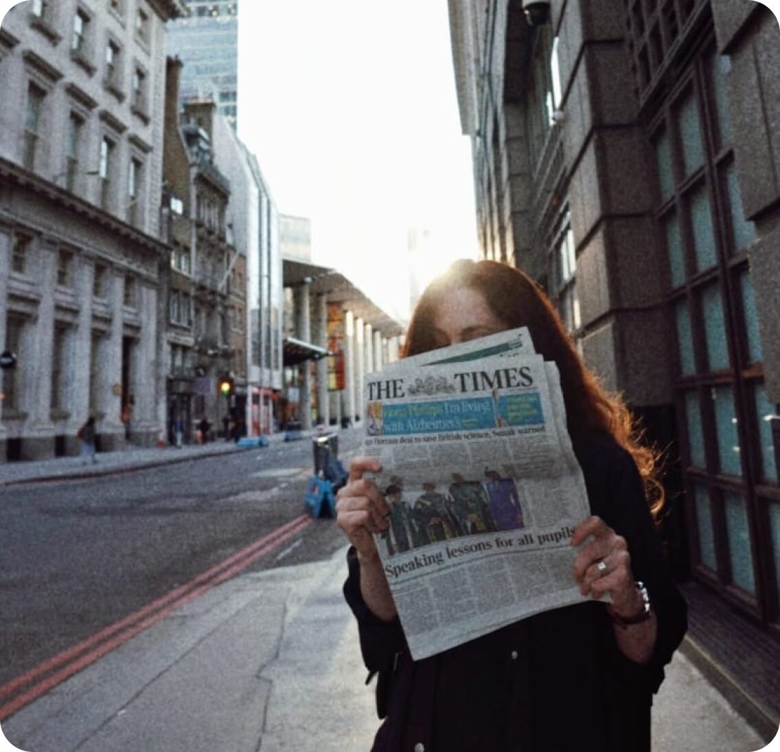 Tanya Donska holding a newspaper on a London street